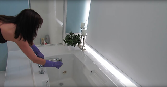 Maid cleaning a bathroom