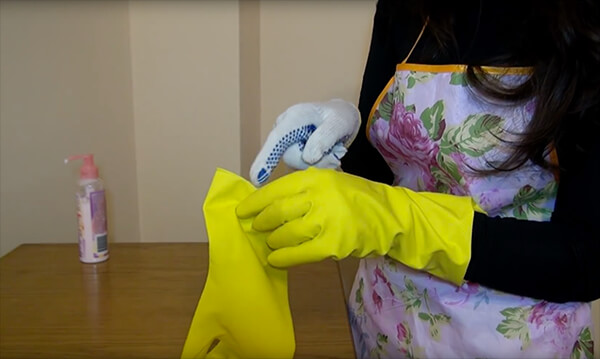 Putting on rubber gloves before cleaning